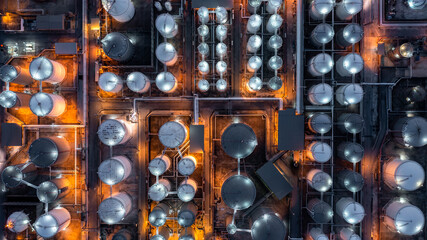 Aerial view chemical storage tank on sea at oil terminal station at night, Chemical plant petroleum and petorchemical product, Chemical industry plant in refinery at night,