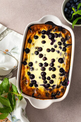 Delicious sweet cheesecake with blueberries in an oval dish, top view