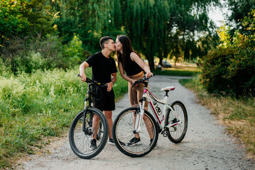 Fototapeta na wymiar Happy young smiling couple with bicycles outdoor