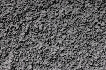 Background with an abstract pattern of textured plaster with nodules on the wall.