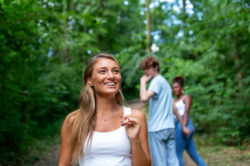 Disloyal man walking with his girlfriend and looking amazed at another seductive girl