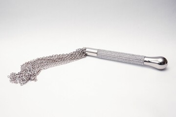 Kinky shiny chain whip isolated on a white background