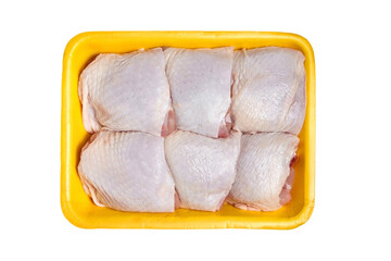 Raw chicken thighs in a yellow tray, top view, isolated