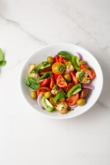 Fresh tomato slices salad with pesto and red onions croutons food