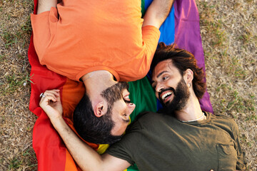 Happy couple with a pride flag. LGBT community..