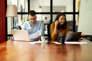 Colleagues in office. Businesswoman and businessman working on the project.