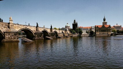 Beautiful view of stone arch Charles Bridge crossing the Vltava river in Prague