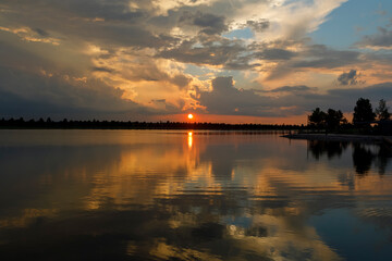 Dramatic sunset and reflections on the water on Patriot Lake in Shelby Farms Park, Memphis, TN.