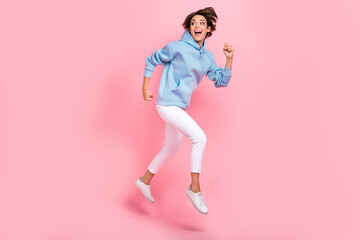 Fototapeta na wymiar Full length photo of astonished pretty lady dressed blue sportswear run interesting look empty space isolated on pink color background
