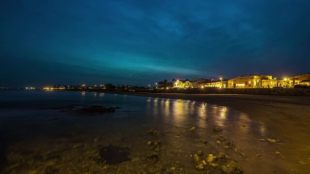 Timealapse: Spiaggia Marina Vecchia sea beach at night with illuminated resort view in Avola, Eloro, Italy