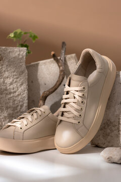 Comfortable sneakers on stone. Concept active eco lifestyle, cusual, shoes for moms, business woman, handmade. vertical
