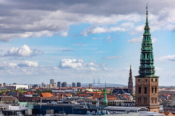 Copenhagen, Denmark Rooftops of the city.and the St Nikolaj Church, now a contemporary art center, and the Oresudn bridge to Sweden in the distance.