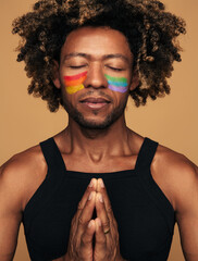 Calm black gay praying with clasped hands