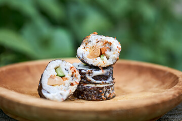Sushi, a Japanese dish of prepared vinegared rice. Sushi is traditionally made with medium-grain white rice, though it can be prepared with brown rice or short-grain rice.