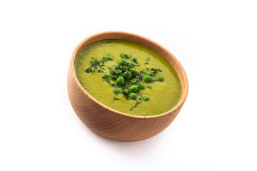 Green pea soup in a bowl isolated on white background