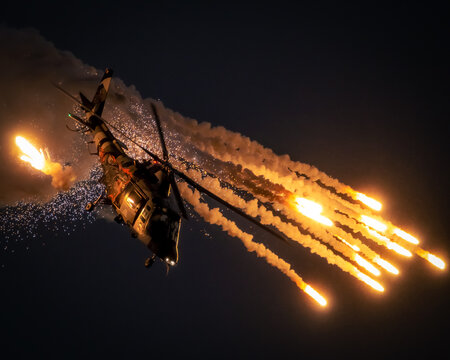Belgian Air Force Agusta A109 helicopter firing flares during a flight demonstration at the Sanice Sunset Airshow..