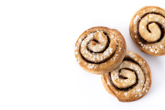 Cinnamon rolls buns. Kanelbulle Swedish dessert isolated on white background. Top view. Copy space