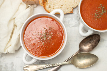 fresh cold tomato soup with herbs in the bowl