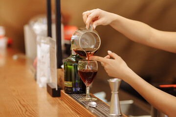 Preparation of coffee in a coffee shop by the hands of a barista using a professional coffee machine