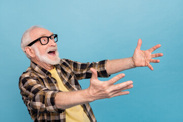 Photo of excited pretty man pensioner dressed checkered shirt eyewear looking up catching empty...