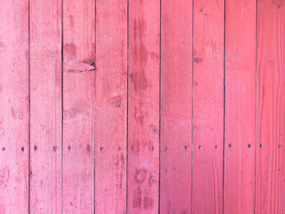 Pink planks as background. Texture of old worn wooden boards used for hardwood flooring outdoor.