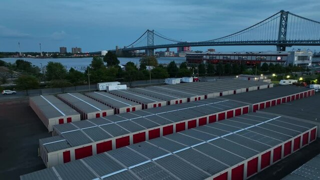 Storage facility near the Ben Franklin Bridge in Philadelphia. Aerial descent at dusk.