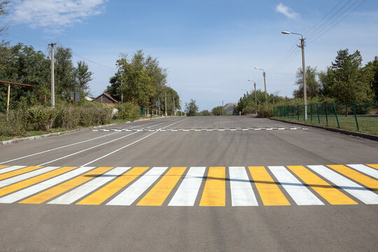 White and yellow pedestrian crossing in rural area in Russia
