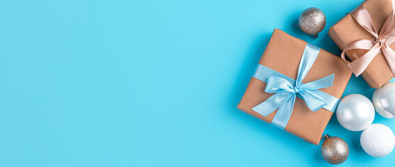 Obraz na płótnie Canvas Christmas gifts and toys on a light blue background. Top view, copy space