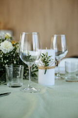 in a bright room, with daylight, a festive table is decorated, with plates and glasses
