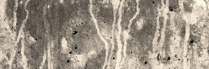 Texture of old concrete wall. Rough gray concrete surface with spots and smudges. Wide panoramic background for design.