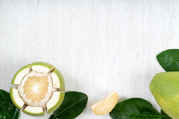 Fototapeta na wymiar Fresh pomelo fruit on white table background.