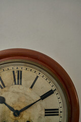 Details of an old clock on white wall