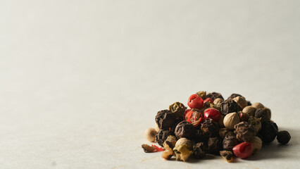 Details of a mountain of colored pepper on a white background