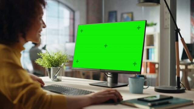 Confident Arab Businesswoman Working on Implementing Modern Business Strategy in Creative Agency. Specialist Writing Corporate Project Plan on Desktop Computer with Green Screen Mock Up Display.