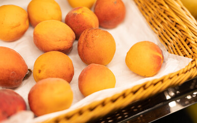 basket of apricots with white paper