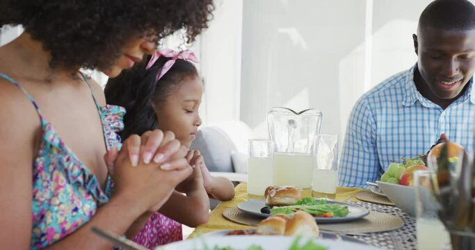 Video of african american family praying together before meal