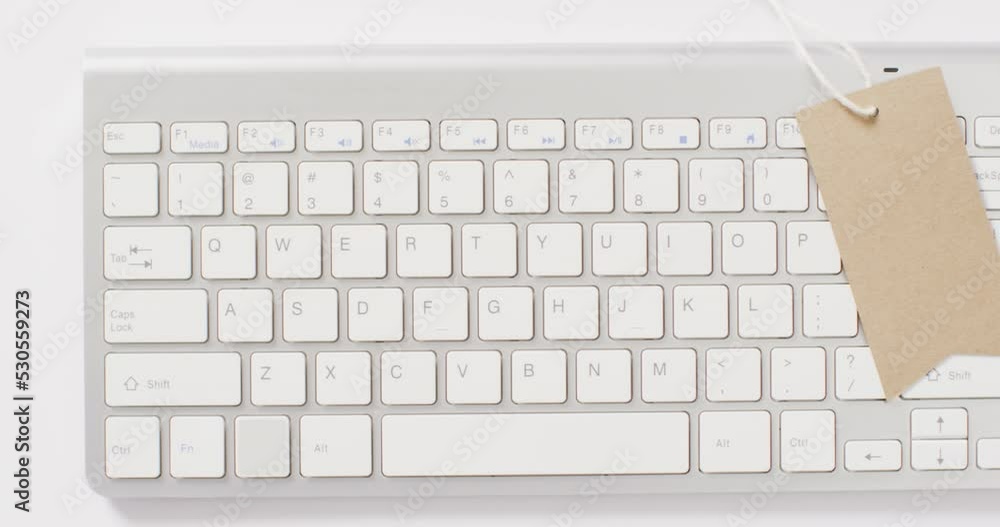 Poster overhead view of brown sale tag on computer keyboard