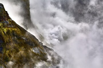 Rough mountain landscape with volcanic steam clouds