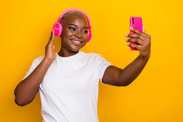 Photo of attractive funny model lady weekend use devices listen sound favorite music playlist isolated on yellow color background