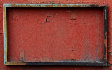 Iron frame on red wall