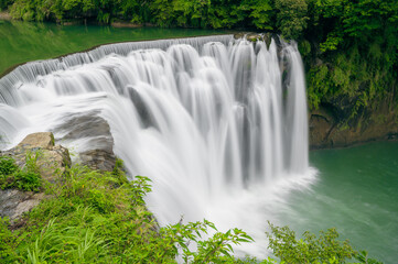 Turquoise streams, green bushes, waterfall views. Refreshing natural landscape. Taiwan