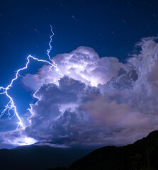 Blue sky, white clouds, lightning and thunder. Huge storm clouds announcing the approach of storms...