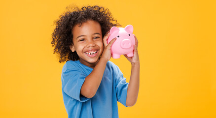 Happy ethnic boy storing money in piggy bank