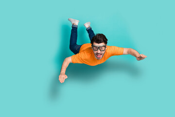 Full body size photo of young funny excited positive guy wear glasses jump air trampoline skydiver...