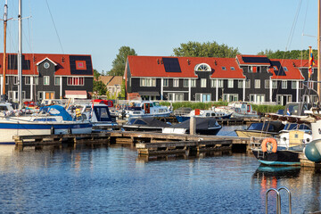 Fototapeta na wymiar Colorful wooden houses in Reitdiephafen in Groningen, the Netherlands