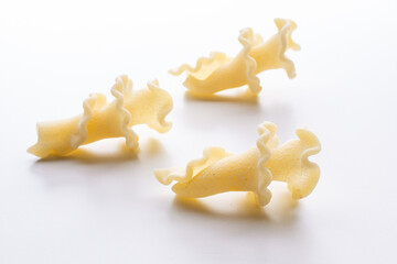 small composition of durum wheat pasta on a white background