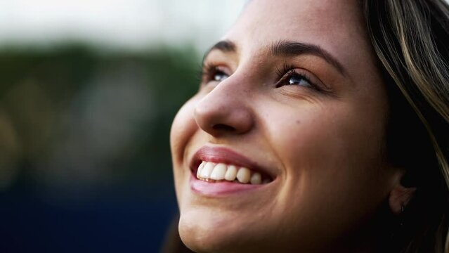 Spiritual young woman opening eyes to sky with HOPE and FAITH. Grateful closeup female face