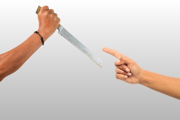 Hand holding knife and pointing gesture, bad situation illustrative.
