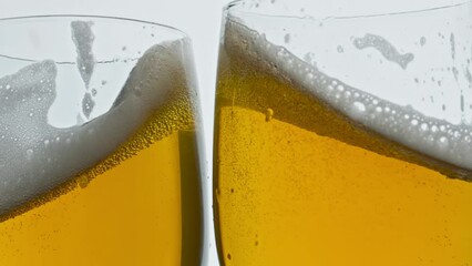 Lager beer glasses cheers gesture closeup. Full ale vessels toasting together