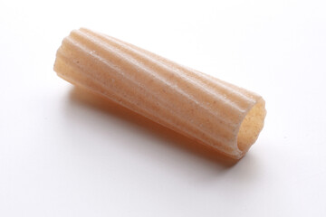 small composition of whole durum wheat pasta on a white background